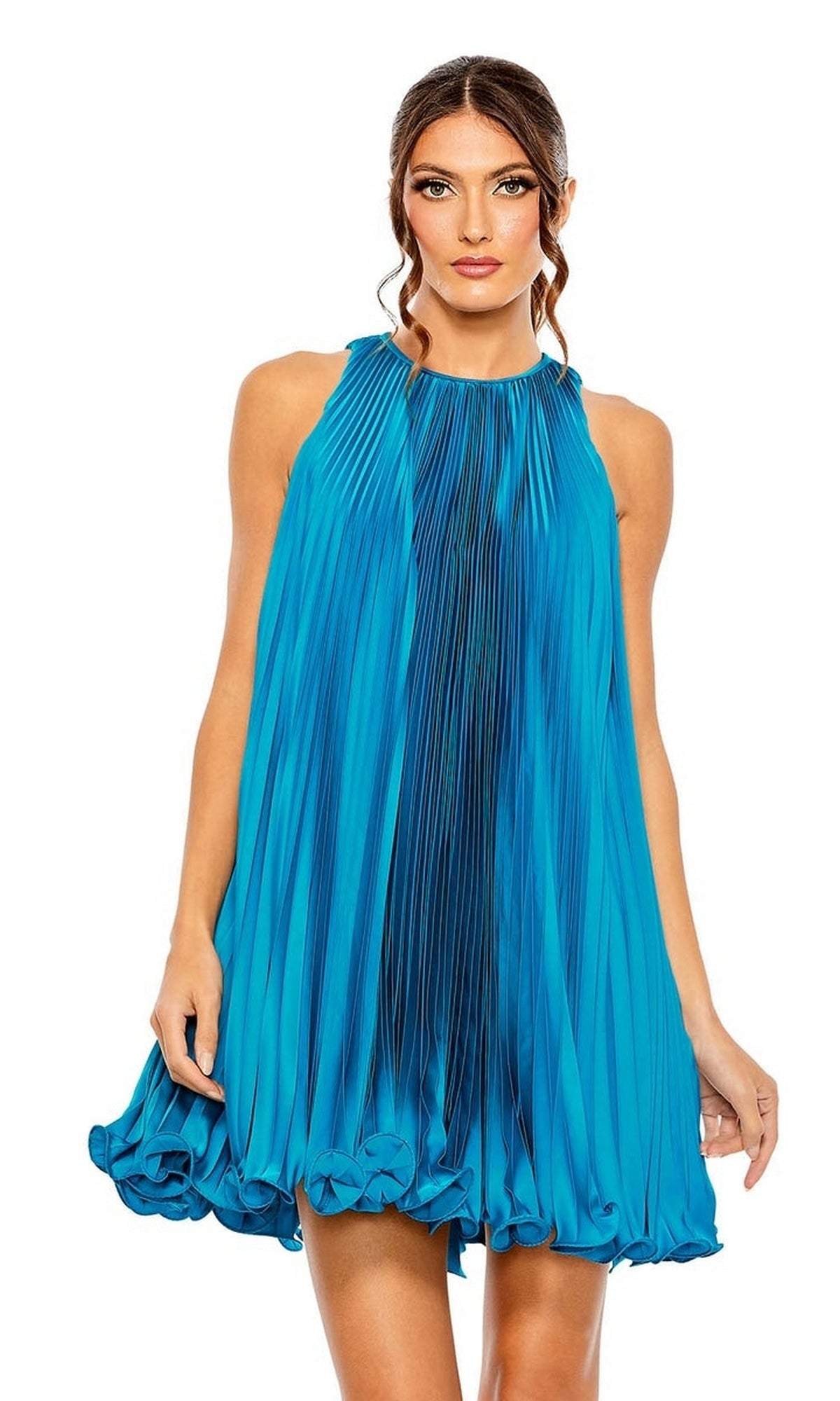 A woman wears the Mac Duggal 49636 short pleated semi-formal dress in bright blue, featuring a high neckline, sleeveless design, and ruffled hem, standing against a white background.